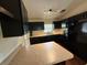 Modern kitchen features dark cabinetry, updated appliances, and a bright countertop, ideal for cooking at 1528 Baltimore Dr, Orlando, FL 32810