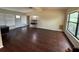 Open-concept living room featuring new floors and an abundance of natural light from large windows at 1528 Baltimore Dr, Orlando, FL 32810