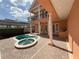 View of the pool, spa, balcony, and outdoor kitchen, all set in a brick paver patio and fenced backyard at 1554 Corolla Ct, Reunion, FL 34747
