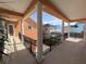 View of balcony with black metal railings and columns looking out to the nearby houses at 1554 Corolla Ct, Reunion, FL 34747