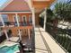 View of balcony with black metal railings and columns looking out to the pool area at 1554 Corolla Ct, Reunion, FL 34747