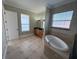 Bathroom featuring a soaking tub, vanity, and lots of natural light at 1554 Corolla Ct, Reunion, FL 34747