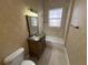 Bathroom featuring tile flooring, decorative sink vanity, and a tub-shower combination with tiled walls at 1554 Corolla Ct, Reunion, FL 34747