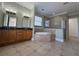 Bright bathroom featuring a soaking tub, walk-in shower, and double vanity at 1554 Corolla Ct, Reunion, FL 34747