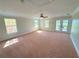 Bright, carpeted bedroom with natural light, neutral walls and private balcony at 1554 Corolla Ct, Reunion, FL 34747