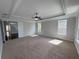 Large bedroom with neutral carpet, a tray ceiling, and an abundance of natural light at 1554 Corolla Ct, Reunion, FL 34747