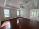 Spacious bedroom with hardwood floors, tray ceiling, and plenty of natural light at 1554 Corolla Ct, Reunion, FL 34747