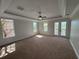 Bedroom with neutral carpet, tray ceiling and views of lake through French doors at 1554 Corolla Ct, Reunion, FL 34747