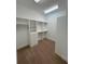 Walk-in closet with built-in shelving and ample storage space at 1554 Corolla Ct, Reunion, FL 34747