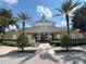 Charming clubhouse with classic architectural details, surrounded by lush landscaping and palm trees at 1554 Corolla Ct, Reunion, FL 34747