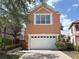 Home with white garage door and neutral, earth-toned paint at 1554 Corolla Ct, Reunion, FL 34747