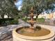 Elegant tiered fountain situated in a beautifully landscaped community area with tree-lined walkway at 1554 Corolla Ct, Reunion, FL 34747