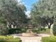 Charming fountain amidst lush greenery and mature trees in a serene community setting at 1554 Corolla Ct, Reunion, FL 34747