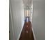 Hallway with hardwood floors and doors to multiple rooms at 1554 Corolla Ct, Reunion, FL 34747