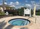 Relaxing hot tub with nearby pool rules and lush greenery for a serene spa-like experience at 1554 Corolla Ct, Reunion, FL 34747
