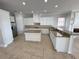 Open kitchen with island, white cabinetry, and granite countertops at 1554 Corolla Ct, Reunion, FL 34747