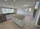 Bright kitchen features granite countertops, stainless steel appliances, and an island at 1554 Corolla Ct, Reunion, FL 34747