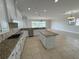 Bright kitchen features granite countertops, stainless steel appliances, and an island at 1554 Corolla Ct, Reunion, FL 34747