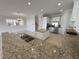 Bright kitchen features granite countertops, stainless steel appliances, and an island at 1554 Corolla Ct, Reunion, FL 34747