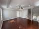 Open living room featuring hardwood floors, a tray ceiling, and staircase at 1554 Corolla Ct, Reunion, FL 34747