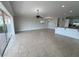 Spacious living room featuring tile floors, ceiling fan, and views of the exterior at 1554 Corolla Ct, Reunion, FL 34747