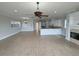 Open-concept living space features a fireplace and neutral tones with lots of natural light at 1554 Corolla Ct, Reunion, FL 34747
