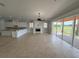 Spacious living area featuring tile floors and a fireplace with access to the outdoors at 1554 Corolla Ct, Reunion, FL 34747
