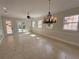 Bright living room featuring tile flooring, a ceiling fan, and views of the pool through glass doors at 1554 Corolla Ct, Reunion, FL 34747