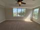 Bright main bedroom with neutral walls, carpeted floor, tray ceiling and views at 1554 Corolla Ct, Reunion, FL 34747