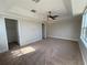 Spacious main bedroom with neutral walls, carpeted floor, tray ceiling and closet at 1554 Corolla Ct, Reunion, FL 34747