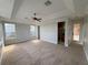 Spacious main bedroom with neutral walls, carpeted floor and several windows at 1554 Corolla Ct, Reunion, FL 34747