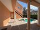 Covered patio with view of pool and spa with brick pavers and staircase leading to an upper level balcony at 1554 Corolla Ct, Reunion, FL 34747