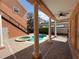 Covered patio and view of pool and spa with brick pavers, exterior staircase and lush backyard landscaping at 1554 Corolla Ct, Reunion, FL 34747