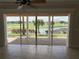 Stunning view through sliding glass doors of the golf course, lake and lush landscaping from the living space at 1554 Corolla Ct, Reunion, FL 34747
