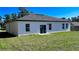 Exterior back view of a single-Gathering home with a well maintained backyard and multiple windows at 16358 Sw 27Th Terrace Rd, Ocala, FL 34473