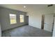 Bright bedroom with neutral paint, modern floors, two windows and an attached bathroom at 16358 Sw 27Th Terrace Rd, Ocala, FL 34473