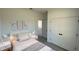 Bright bedroom with white walls, twin bed, gray floors and a closet with double doors at 16358 Sw 27Th Terrace Rd, Ocala, FL 34473
