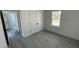 Well-lit bedroom featuring a window, closet with double doors and gray floors at 16358 Sw 27Th Terrace Rd, Ocala, FL 34473