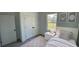 Comfortable bedroom with closet, large window, carpet and a fresh coat of paint at 16358 Sw 27Th Terrace Rd, Ocala, FL 34473