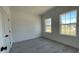 Bedroom with two windows and gray floors at 16358 Sw 27Th Terrace Rd, Ocala, FL 34473