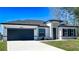 Beautiful single Gathering home with a white exterior, gray accents, well-manicured lawn, and a two car garage at 16358 Sw 27Th Terrace Rd, Ocala, FL 34473