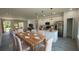 Bright, open-concept kitchen and dining area with a modern island and stainless steel appliances at 16358 Sw 27Th Terrace Rd, Ocala, FL 34473