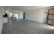 Open-concept living room and kitchen area with wood-look flooring and plenty of natural light at 16358 Sw 27Th Terrace Rd, Ocala, FL 34473