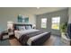Serene main bedroom featuring a plush bed, stylish decor, and abundant natural light at 16358 Sw 27Th Terrace Rd, Ocala, FL 34473