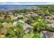Expansive aerial view of a lakeside community with mature landscaping and inviting homes at 205 Torcaso Ct, Winter Springs, FL 32708