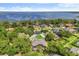 Aerial view of a luxury home with a screened pool, nestled in a lush community near the water at 205 Torcaso Ct, Winter Springs, FL 32708