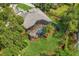 Aerial view showcasing the home's backyard pool, screened in porch, and well-kept landscaping at 205 Torcaso Ct, Winter Springs, FL 32708