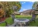 Lush backyard with a cozy fire pit and seating area, great for outdoor gatherings at 205 Torcaso Ct, Winter Springs, FL 32708