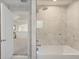 Bright bathroom with a shower and bathtub combination, and a view into the adjacent room from the doorway at 205 Torcaso Ct, Winter Springs, FL 32708
