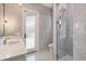 A modern bathroom with marble tile, a glass-enclosed shower, and a white vanity at 205 Torcaso Ct, Winter Springs, FL 32708